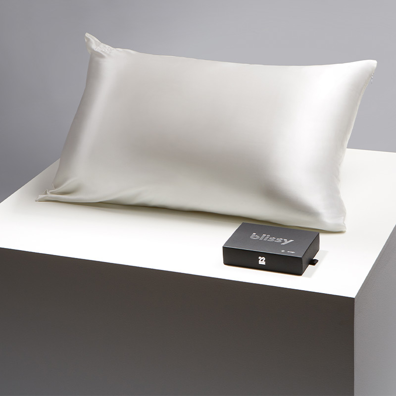 Product shot of a luxurious white Blissy pillowcase, showcasing its smooth and elegant silk fabric